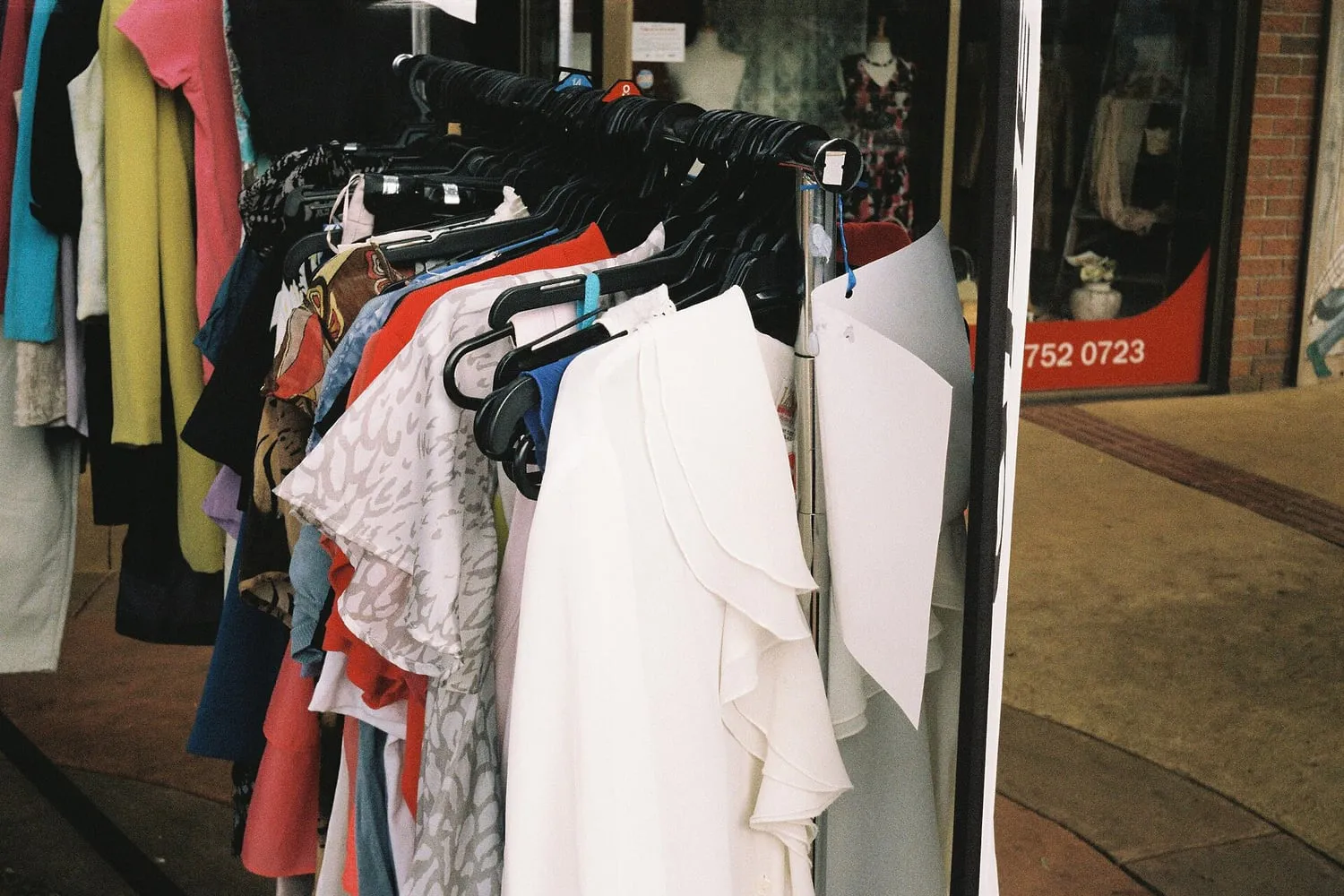Clothing on a rail in a secondhand shop